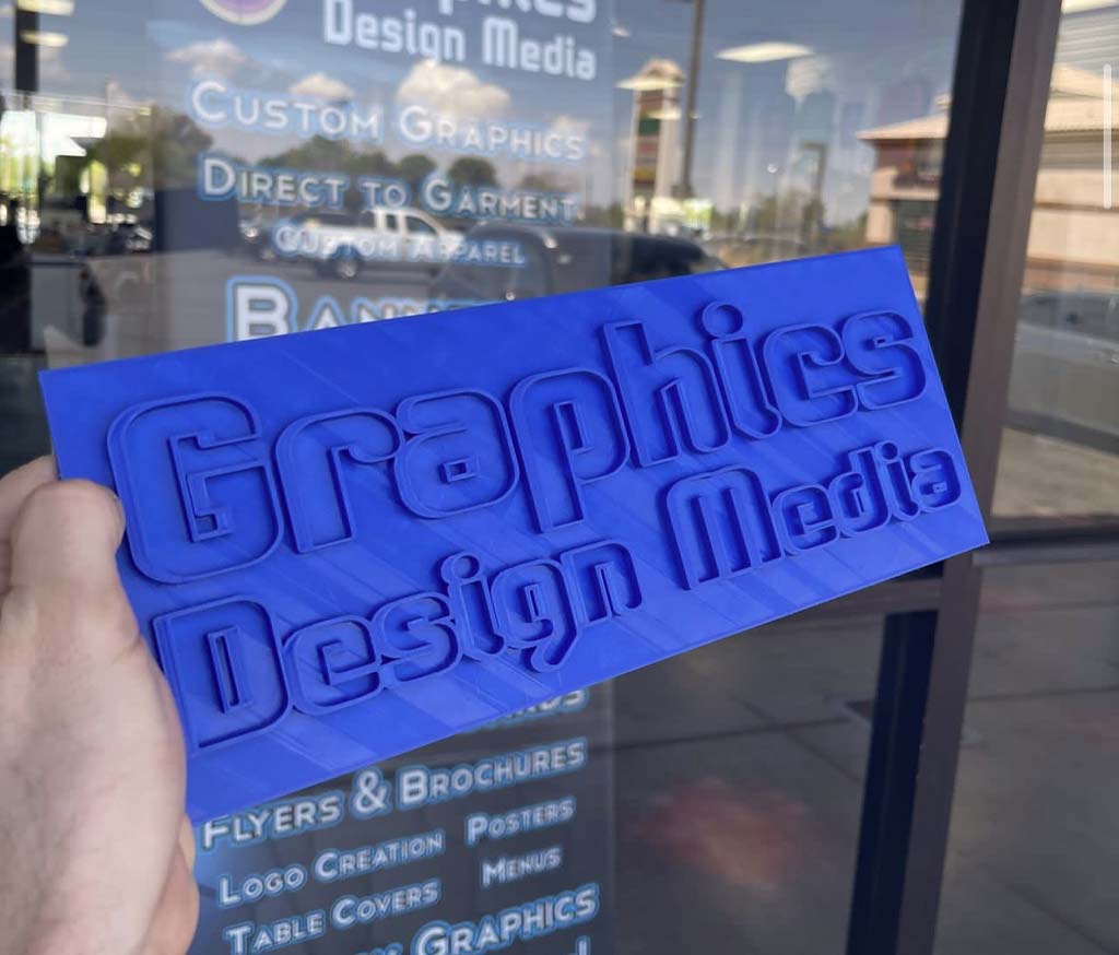 graphics design media 3d print in blue in front of our las vegas print shop and graphic design studio